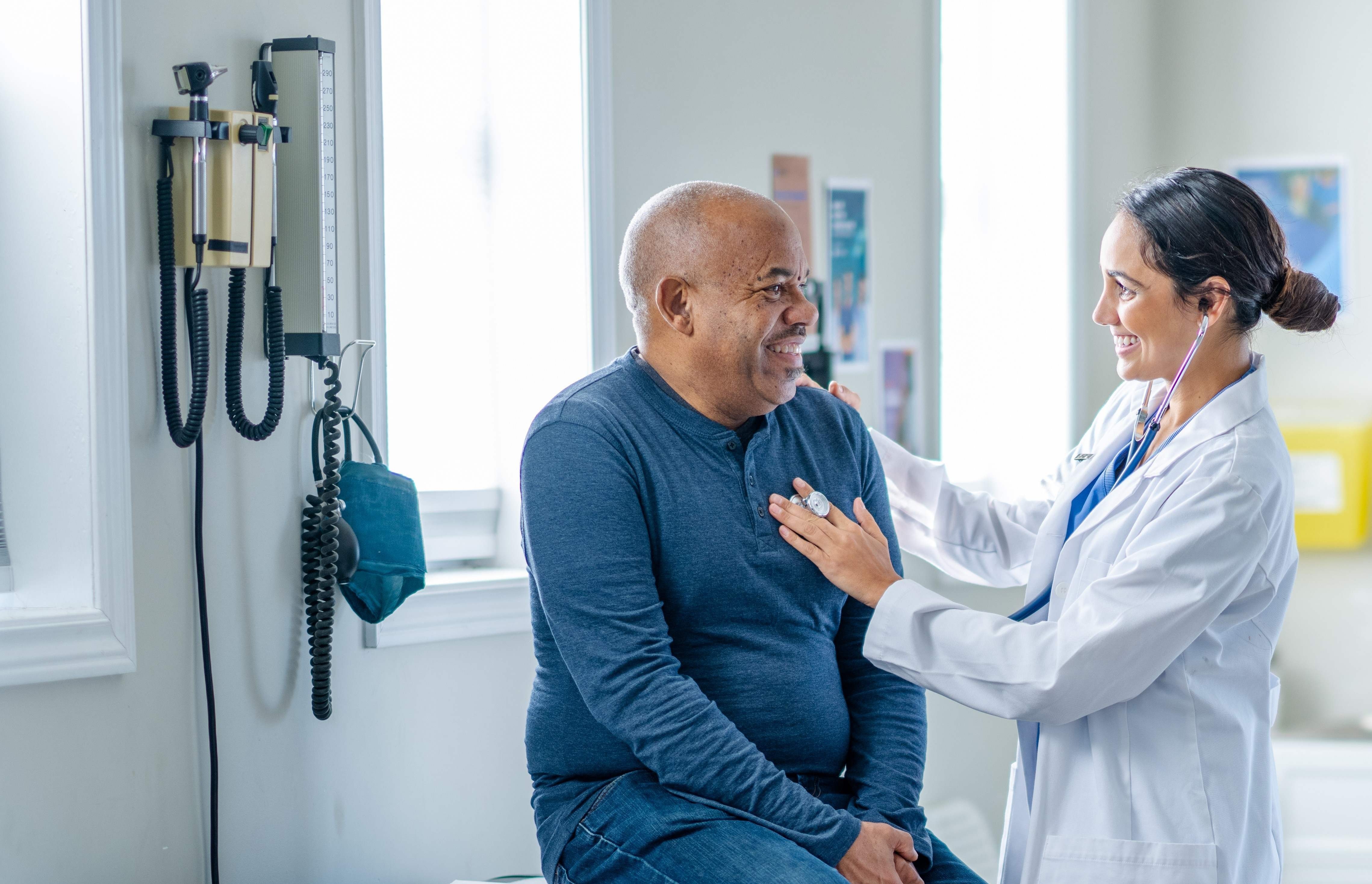 Physician assistant sitting with a patient
