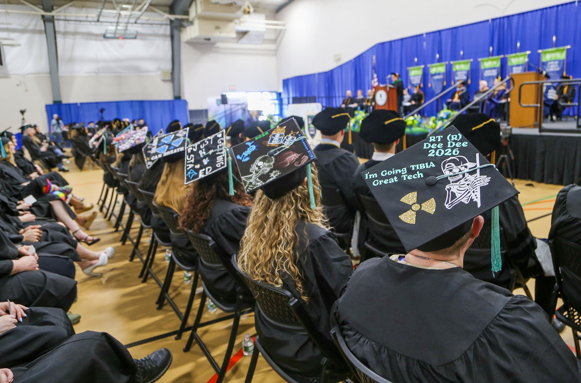 Students sitting with decorated tassles during graduation