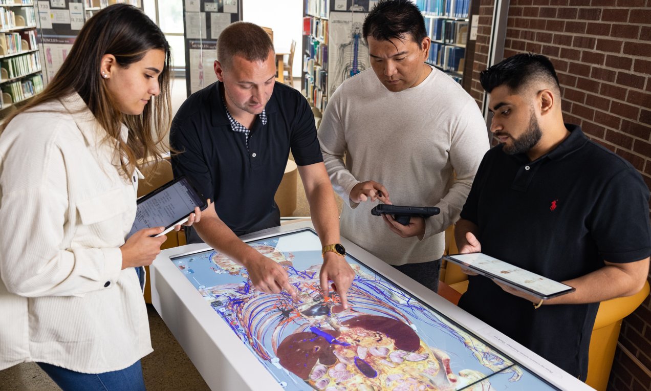 students and an instructor using the anatomage table