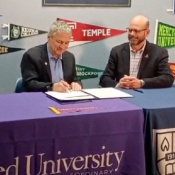 Alfred University President and Northeast College President sit down together for the signing of a new educational partnership