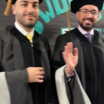 Northeast College graduates waving at the camera before they walk at Commencement