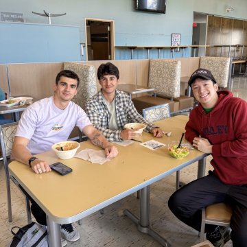 Students on campus sitting at a table during the start of the spring semester 