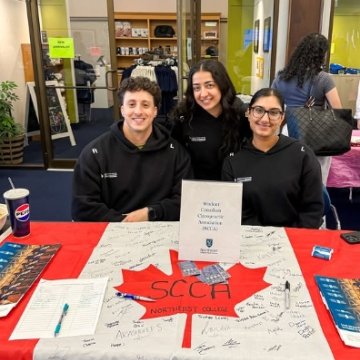 students in the SCCA club on campus posing for a photo during the Spring Tri Club Fair