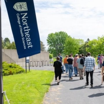 Prospective massage therapy students on campus with their families during Massage Therapy Discovery Day, where they learned more about the programs and experienced the Seneca Falls campus in person. 