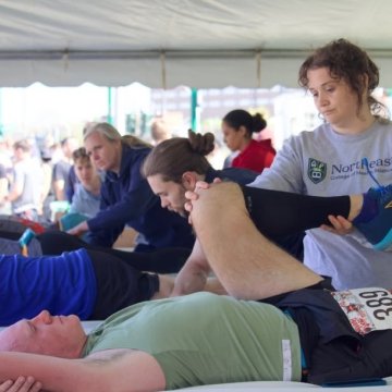 Doctor of Chiropractic students adjusting at a clinic in Syracuse