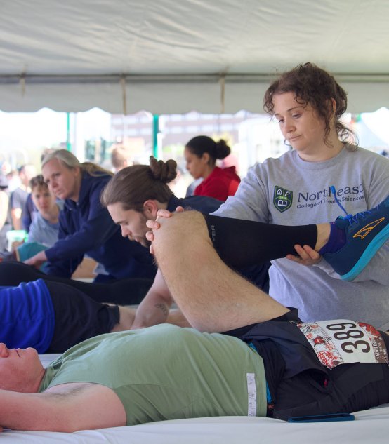 Northeast chiropractic workers in tent at fitness event