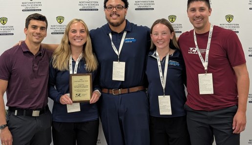 Four students posing with their Student Chapter of the Year award and Dr. Balseca