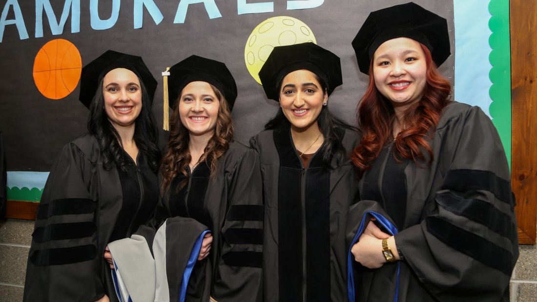 Graduates posing for a photo at Commencement