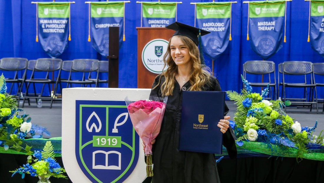 A graduate walking at Commencement