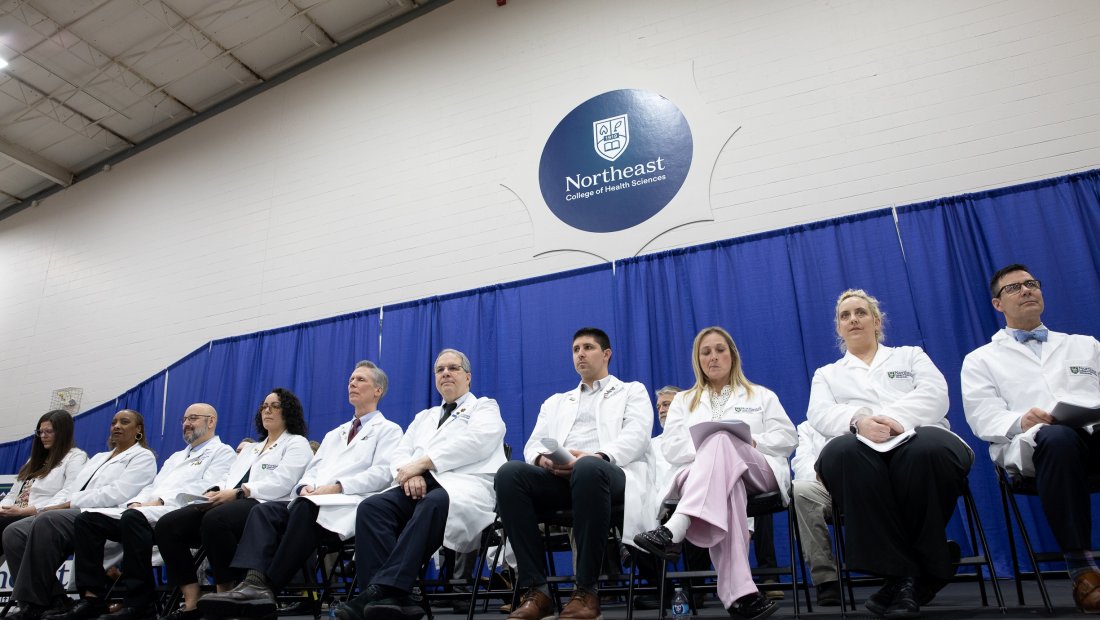 Faculty and Staff sitting on stage at Transitions