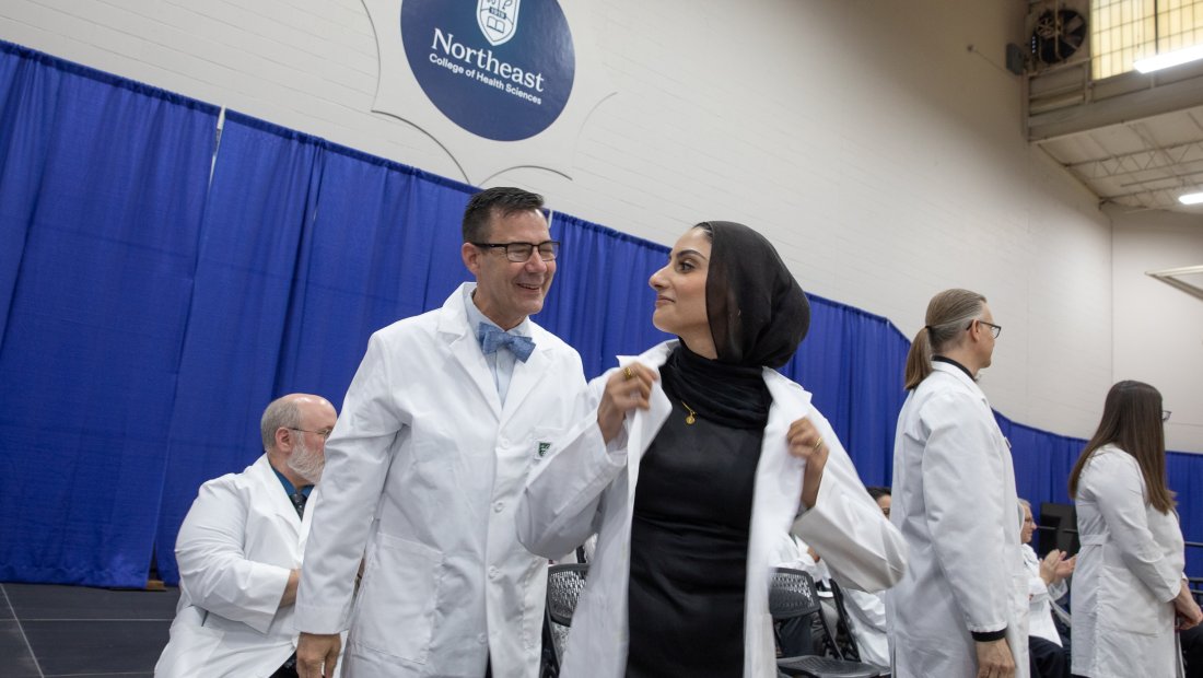 A 7th trimester student receiving their white coat at Transitions Ceremony