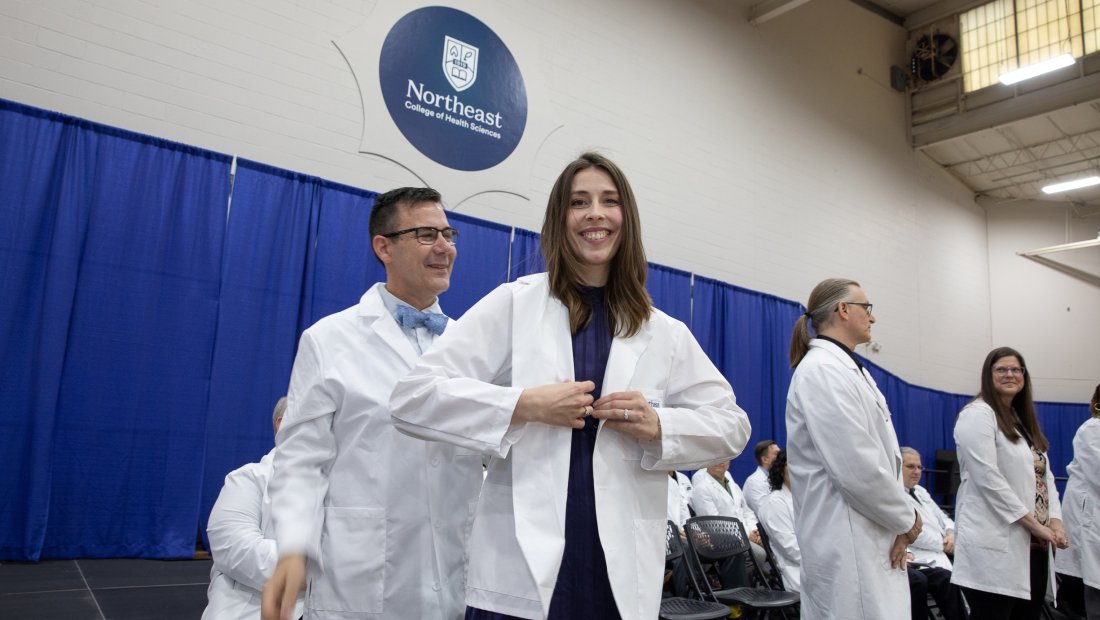 A 7th trimester student receiving their white coat at Transitions Ceremony