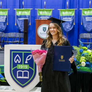 A graduate walking at Commencement