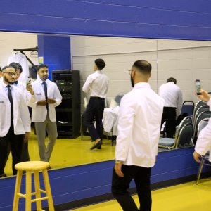 7th Trimester students posing for photos in their white coats at Transitions Ceremony