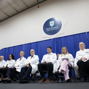 Faculty and Staff sitting on stage at Transitions