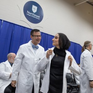 A 7th trimester student receiving their white coat at Transitions Ceremony