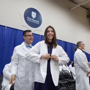 A 7th trimester student receiving their white coat at Transitions Ceremony